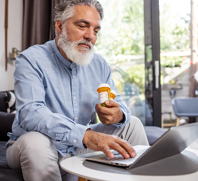 A specialty pharmacy patient managing his prescriptions online