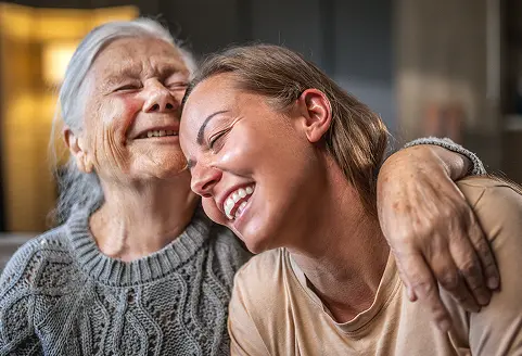 A specialty pharmacy patient and her grandaughter laughing together